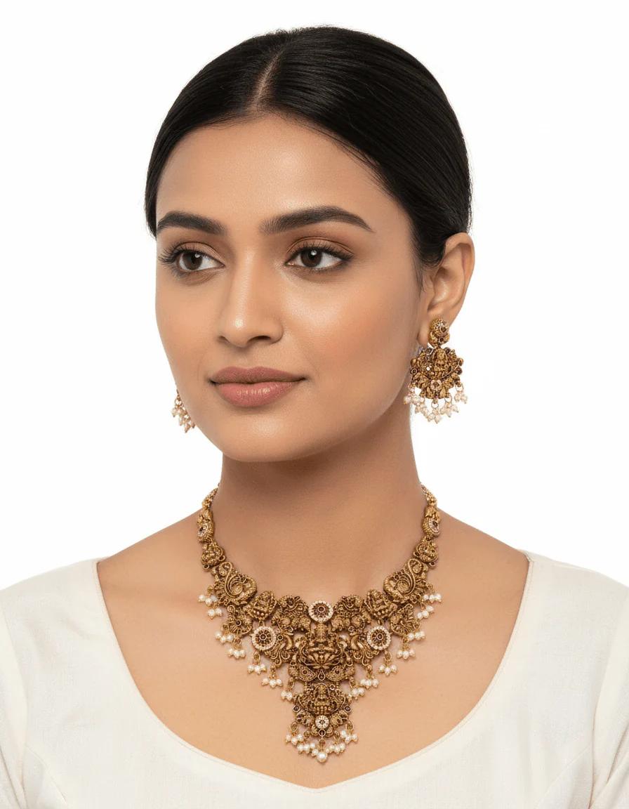 Gold-Plated Temple Jewelry Set with Lakshmi Necklace and Jhumka Earrings – Antique Finish Ruby & Emerald Bridal Jewelry for Weddings & Festivals
